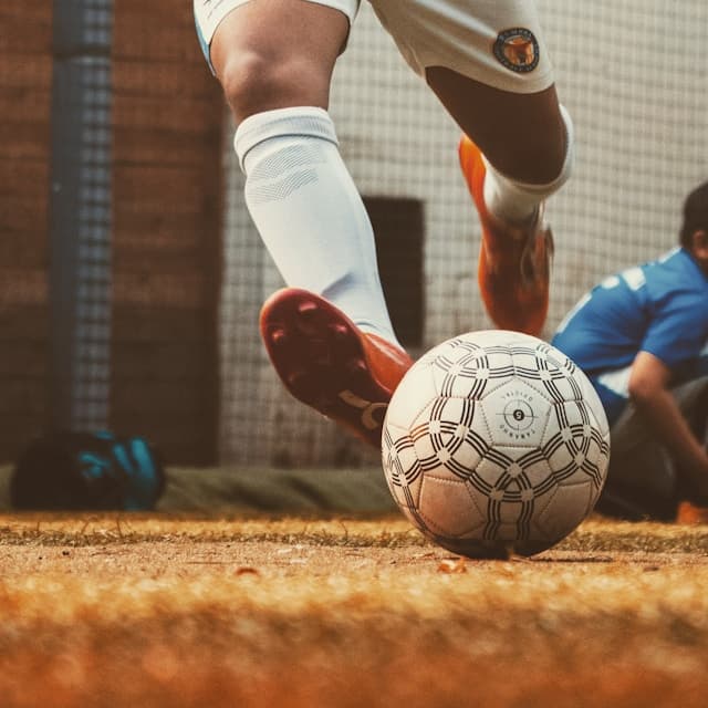 Boot striking a ball on indoor turf